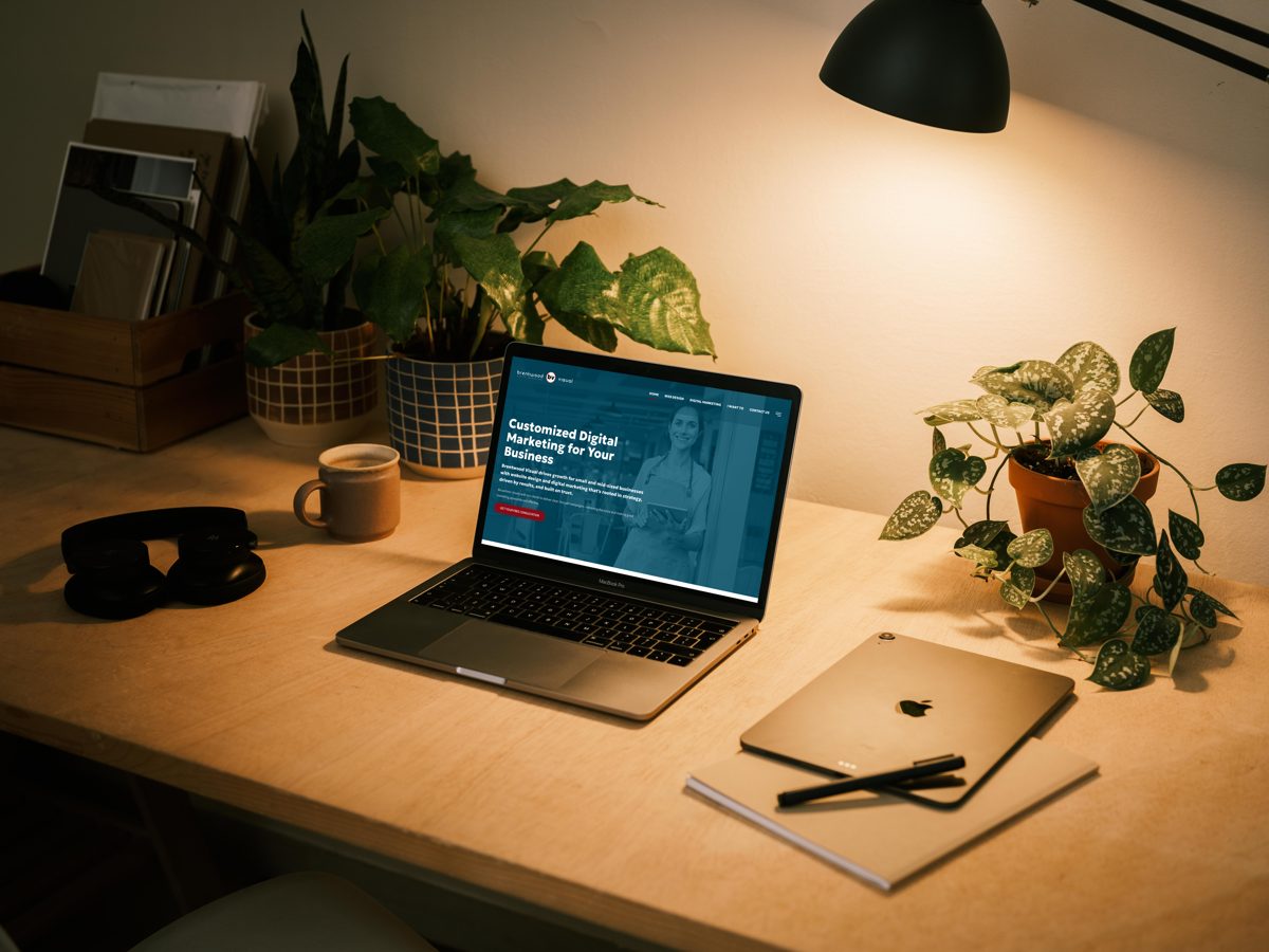 A small-business website open on a laptop on a warmly lit desk
